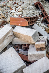 Background of building rubble with terracotta bricks and other white stone bricks very famous in Sicily.