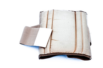 Close up of medical heat waist belt for lower back pain or back pain isolated on white used by both men and women.