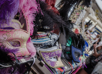 Extreme close up of some colorful carnival masks at a banquet for tourists, at the most famous market in the city of Verona.