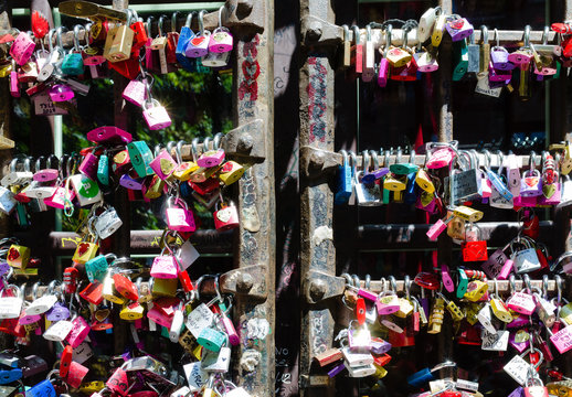 Detail of the entrance door to the Giulietta house in Verona. Full of colorful padlocks left by lovers on the promise of respect for mutual love. Concept of loyalty in love.