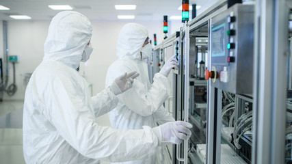 Team of Scientists in Sterile Protective Clothing Work on a Modern Industrial 3D Printing...