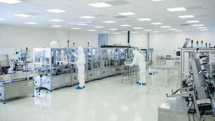 Shot Of Sterile High Precision Manufacturing Laboratory where Scientists in Protective Coverall's...