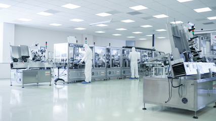 Sterile High Precision Manufacturing Laboratory where Scientists in Protective Coverall's Turn on...
