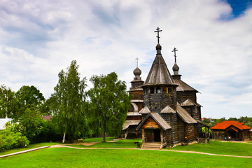 Wooden Orthodox church on green grass