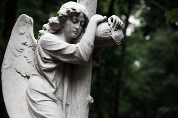 The Sorrowful Angel. Marble mourning angel with a cross, space for text