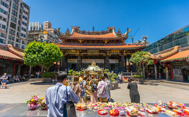 Crowd of people make a pray at Longshan Temple in Taipei, Taiwan