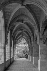 Panoramic view of a beautiful arcade with vaulted ceilings in a reconstructed monastery in Xativa, Spain. Black and white image