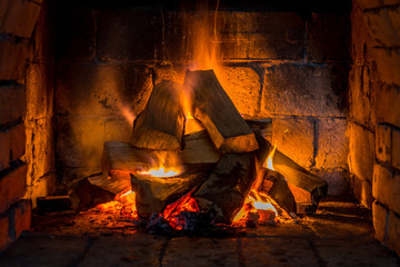 Wood burning in a cozy fireplace at home, keep warm