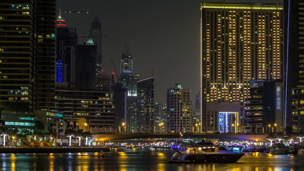 Fototapeta na wymiar Promenade in Dubai Marina timelapse at night, UAE.