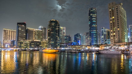 Fototapeta na wymiar View of Dubai Marina Towers and yahct in Dubai at night timelapse hyperlapse