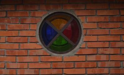 Obraz na płótnie Canvas colorful window and the brick wall 