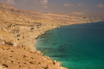 Arabian Sea and rocky mountains. A typical landscape of south-east Oman.