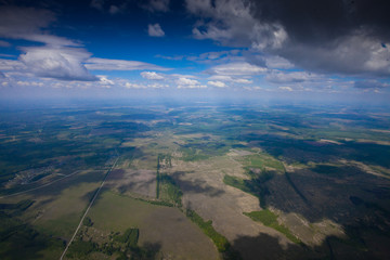 The flight under the blue sky over the summer plain.
