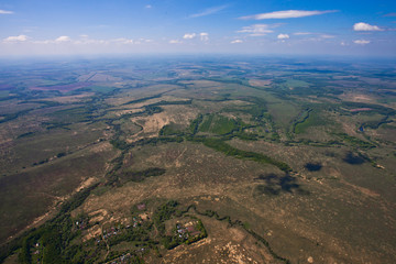 Fototapeta na wymiar Flight over the plain with rivers, fields and forests.