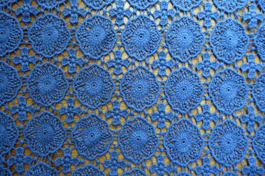 Lacy cotton fabric on wood from above