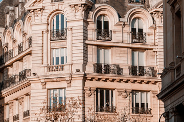 Fototapeta na wymiar View from below on a facade European building with balconies in Paris, France. Neoclassicism architecture style.