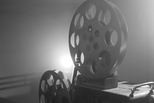Vintage movie projector. Film reels. Black and white. Still life, close-up