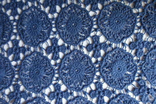 Vintage blue crochet lace on white background from above