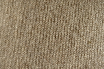 Close up of simple beige knitted fabric