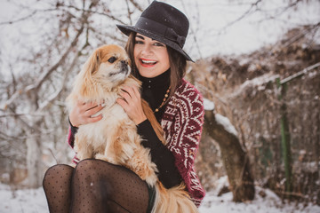 Nice latina woman with little red dog pekingese breed. Pet lover, lady and her best friend on a walk 