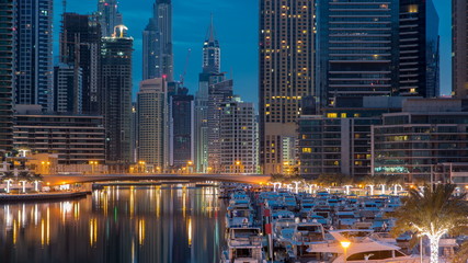 Obraz na płótnie Canvas View of Dubai Marina Towers and canal in Dubai night to day timelapse