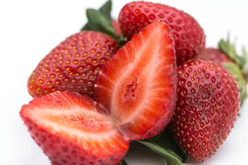 Two halfs of the ripe strawbery on the white background