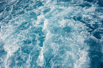 Fototapeta na wymiar Background shot of blue aqua sea water with foam surface