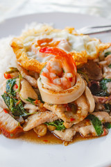 Rice topped with stir-fried all mixed and basil with fried egg.