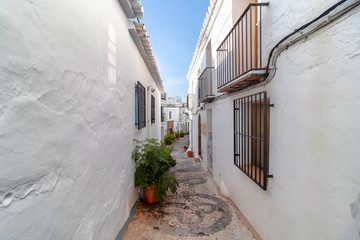 Fototapeta na wymiar Charming narrow historic streets of white village Frigiliana in Malaga province, Andalusia, Spain