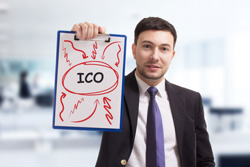 Business, technology, internet and networking concept. Young entrepreneur showing keyword: ICO