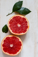 two halves of cut ripe juicy grapefruit on the table