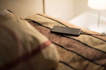 Smartphone is charging on bed, risk of explosion of poor battery quality