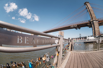 Selective focus on Beautiful word and love locks terrace with blurred Brooklyn bridge background in New York City, USA