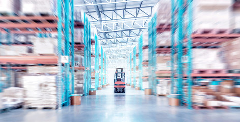 warehouse metal structure interior with  forklift truck in selective focus