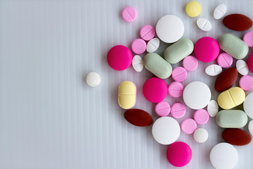 Assorted pharmaceutical medicine pills, tablets and capsules on white  background