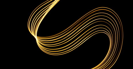 Light painting, long exposure photography, vibrant metallic yellow gold color against a black background