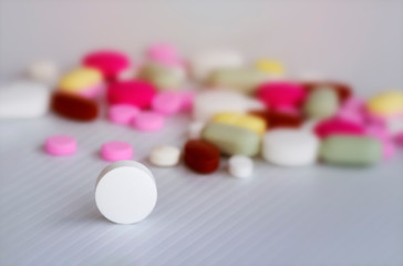 Assorted pharmaceutical medicine pills, tablets and capsules on white  background