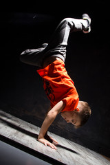 Young russian bboy doing some stunts on the stage