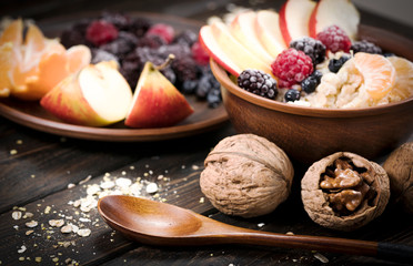 oatmeal with fruit on a wooden background