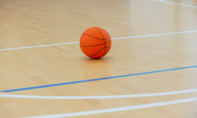 Basketball ball over floor in the gym. Team sport.