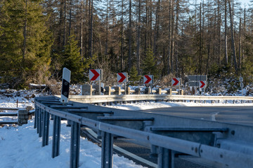 Arrow signs at the side of a street in winter
