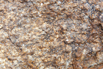 Abstract nature grunge texture background of dark brown granite rock with detail, rough and rustic.