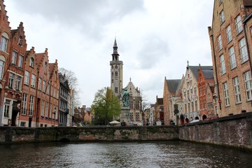 Fototapeta premium Bruges, Belgium. The Poortersloge view from boat trip in the canal of the city.