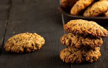 Oatmeal cookies with milk on tray on rustic wooden table