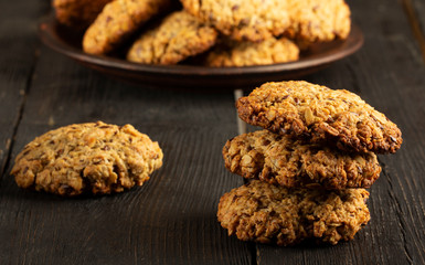 Oatmeal cookies with milk on tray on rustic wooden table