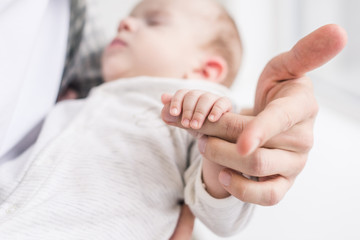 cropped shot of father with littlr baby in hands