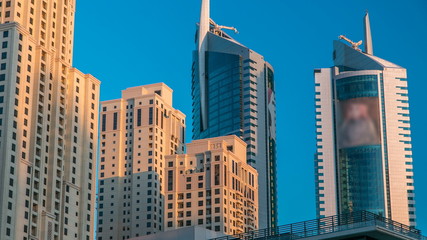 Fototapeta premium Morning view of Dubai Marina Towers in Dubai timelapse