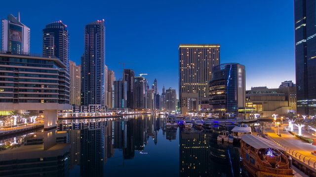 View of Dubai Marina Towers and canal in Dubai night to day timelapse - Powered by Adobe