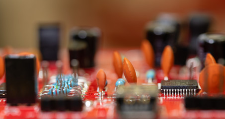 Close up (Macro) of Printed Circuit Board PCB embedded components (inductors, resistors, capacitors, diodes, microchips, transistor) with short depth of view