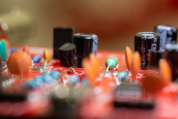 Close up (Macro) of Printed Circuit Board PCB embedded components (inductors, resistors, capacitors, diodes, microchips, transistor) with short depth of view
